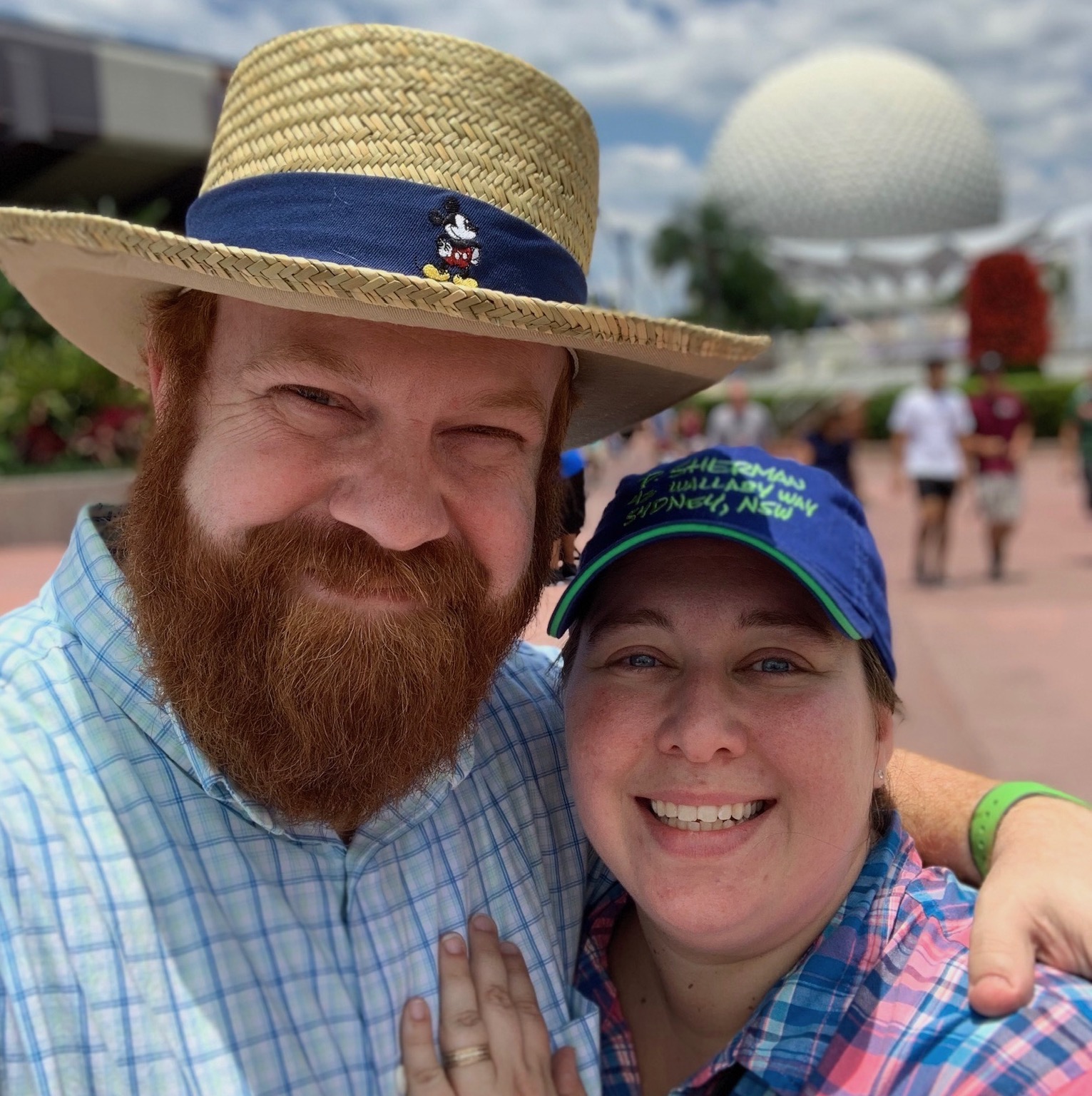 Photo of Ray and Amber Hollister in front of Spaceship Earth which is commonly called "The EPCOT ball"
